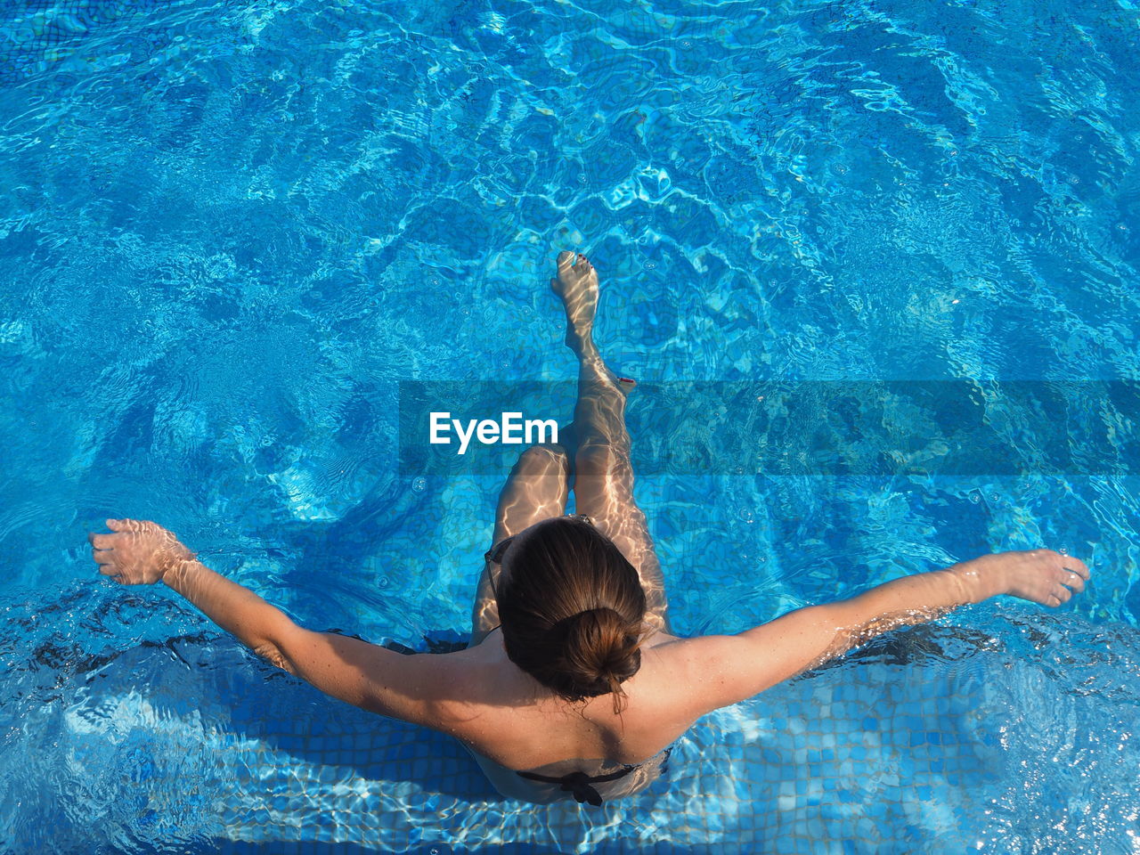 High angle view of woman swimming in pool