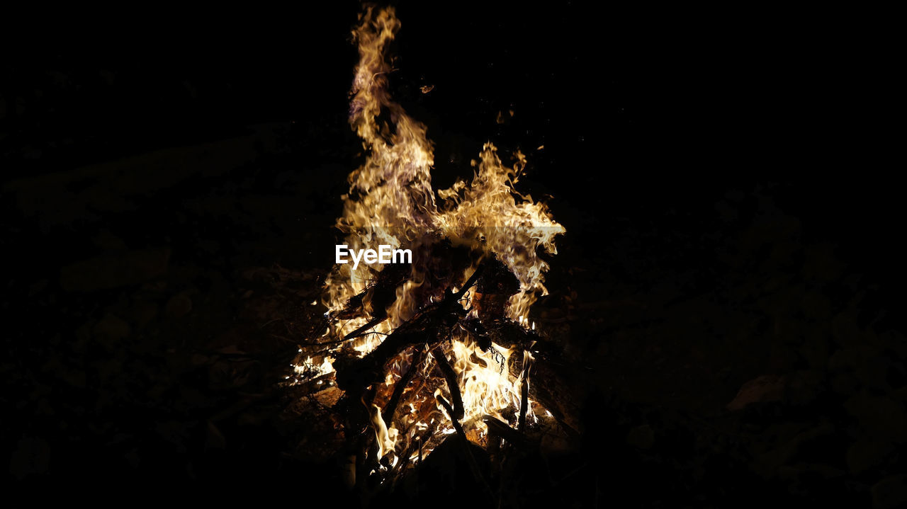 CLOSE-UP OF BONFIRE IN DARK