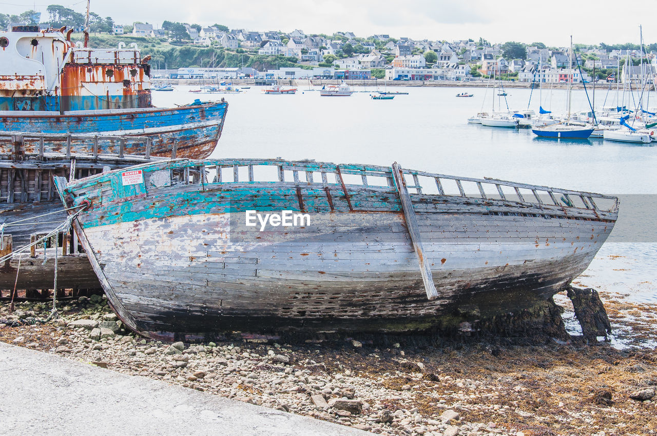 BOATS MOORED AT SHORE