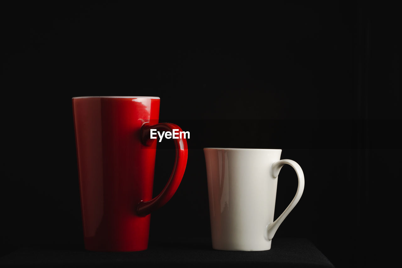 CLOSE-UP OF COFFEE CUP ON BLACK BACKGROUND