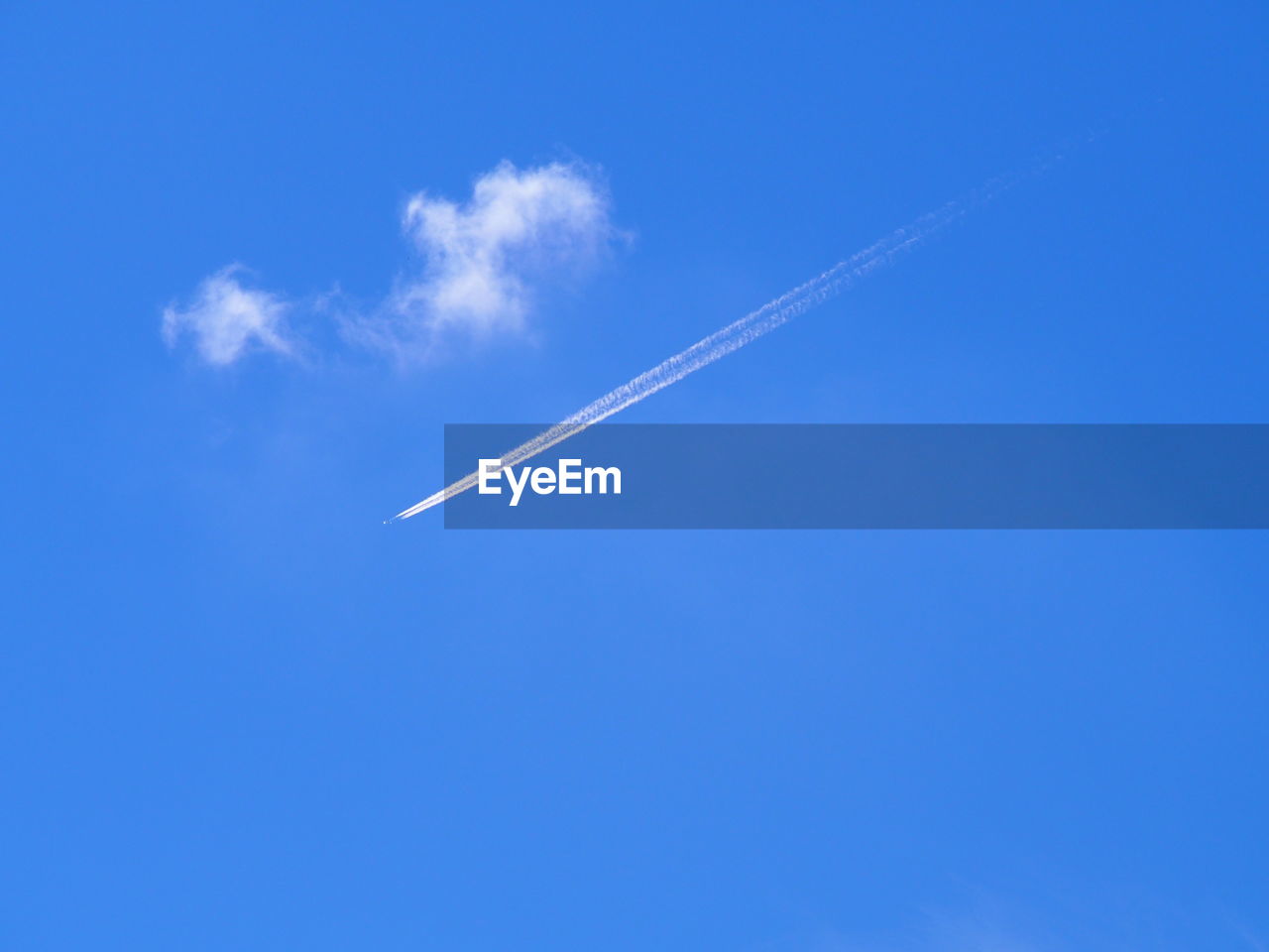 Low angle view of vapor trail against clear blue sky