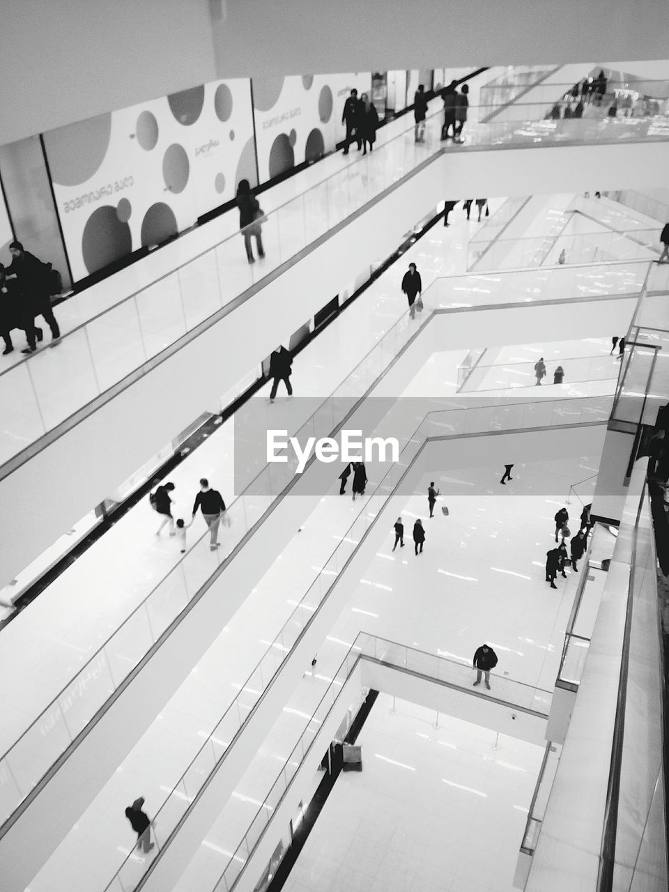 HIGH ANGLE VIEW OF PEOPLE WALKING ON STAIRCASE
