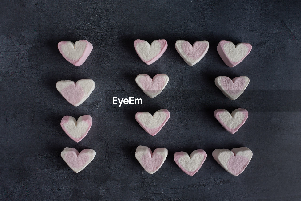 Love heart marshmallows lined up to spell out the number ten viewed from the top down