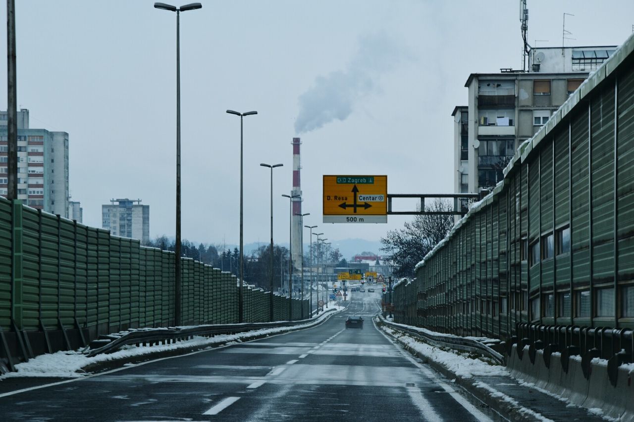 City street during winter against sky