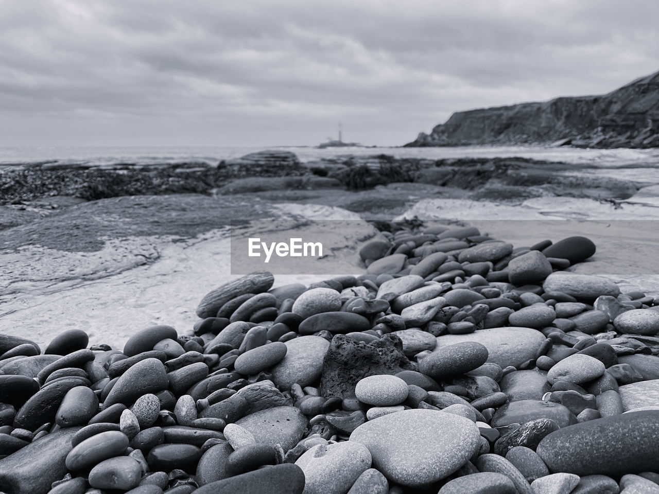 Black and white monochrome pebbles on the beach