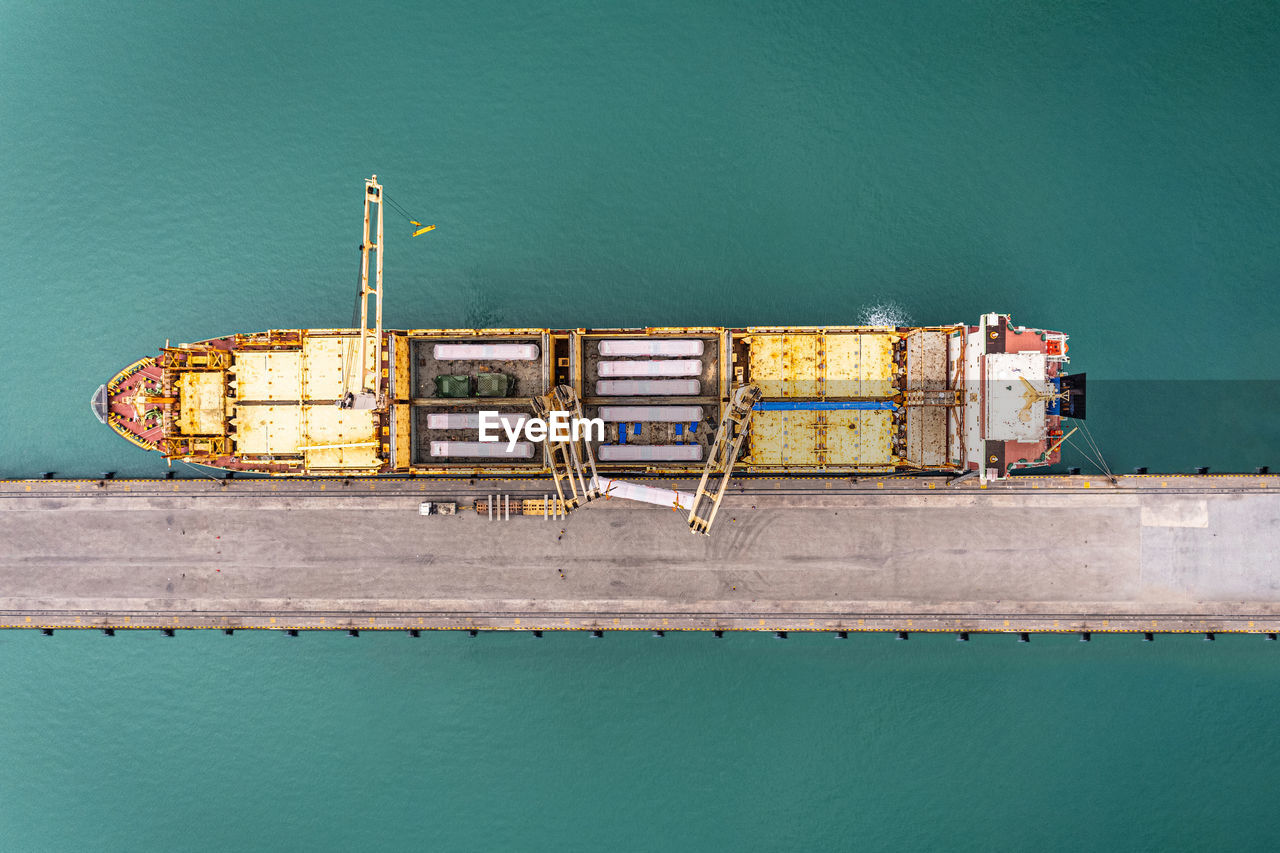 Aerial top view container ship with crane bridge for load container.