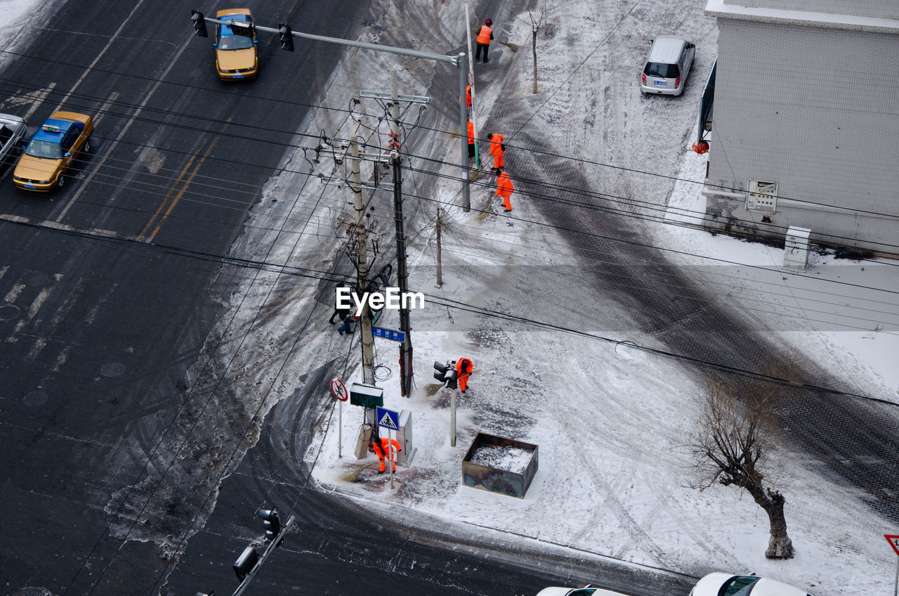 HIGH ANGLE VIEW OF VEHICLES ON SNOW COVERED