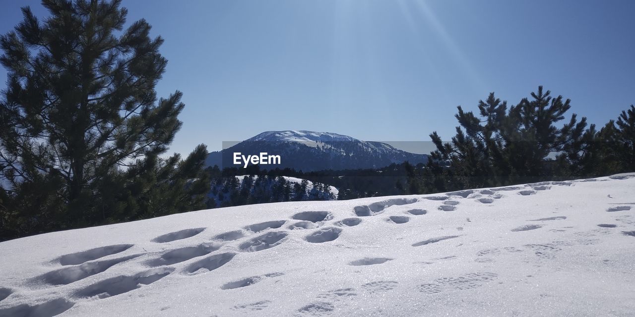 Scenic view of snow covered mountains against sky