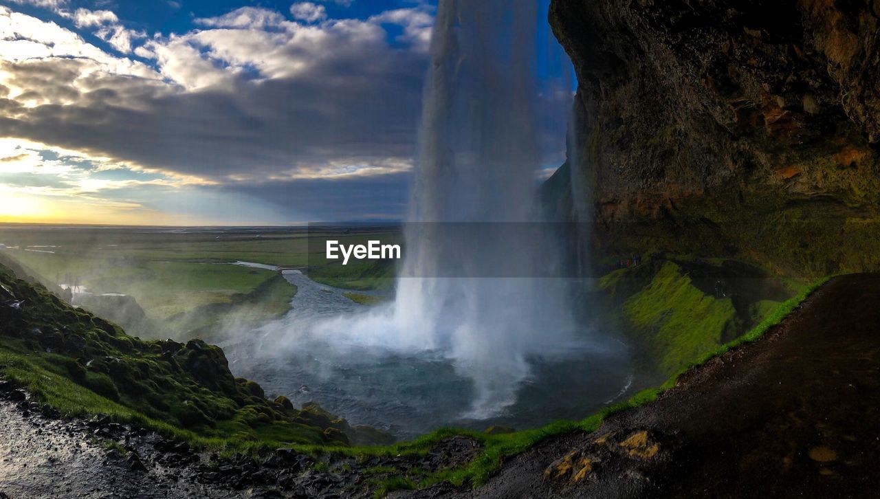 SCENIC VIEW OF WATER FLOWING THROUGH LAND