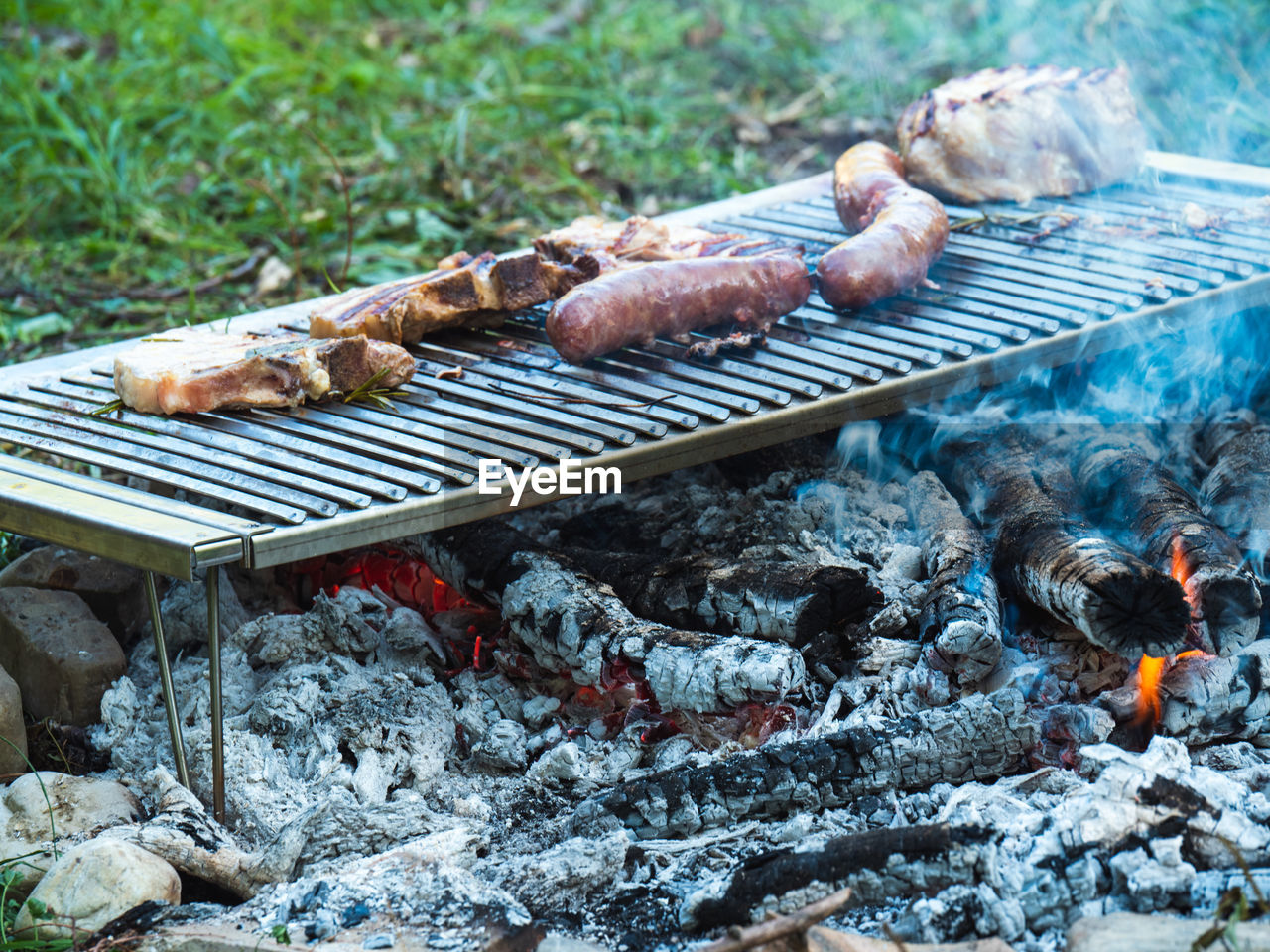 barbecue, barbecue grill, food, food and drink, heat, nature, day, meat, grilled, no people, burning, outdoors, fire, freshness, outdoor grill, grilling, flame, coal, high angle view, cuisine, sausage, land, animal, wood, dish
