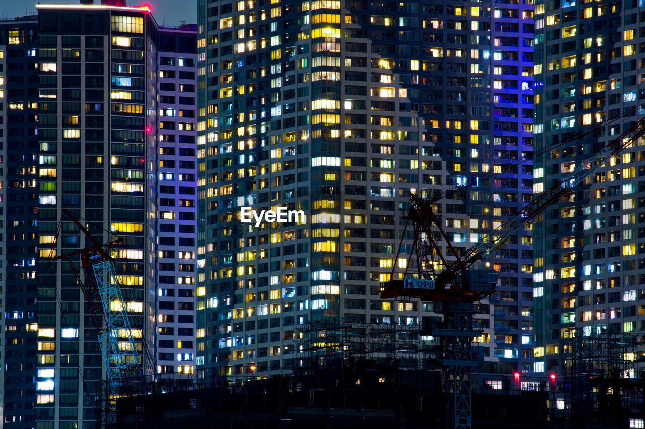 Illuminated modern buildings in city at night