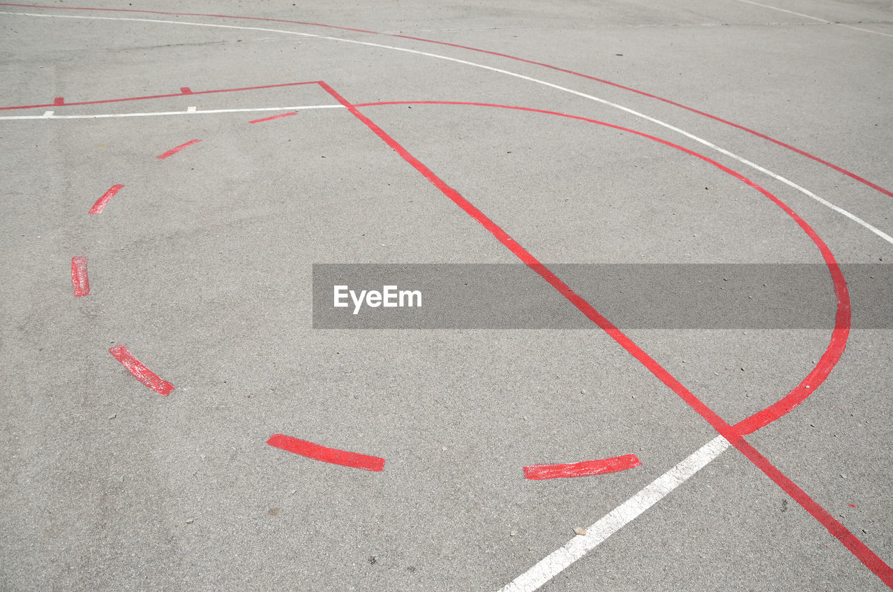 Part of basketball playground with red and white lines