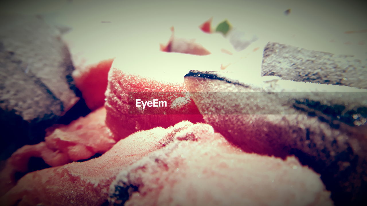 CLOSE-UP OF MAN HOLDING ICE