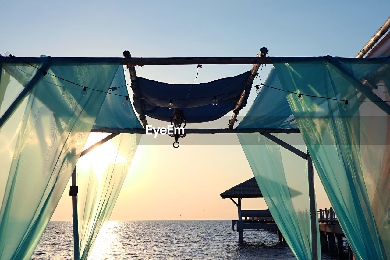 Romantic tent on the beach against gorgeous sunset