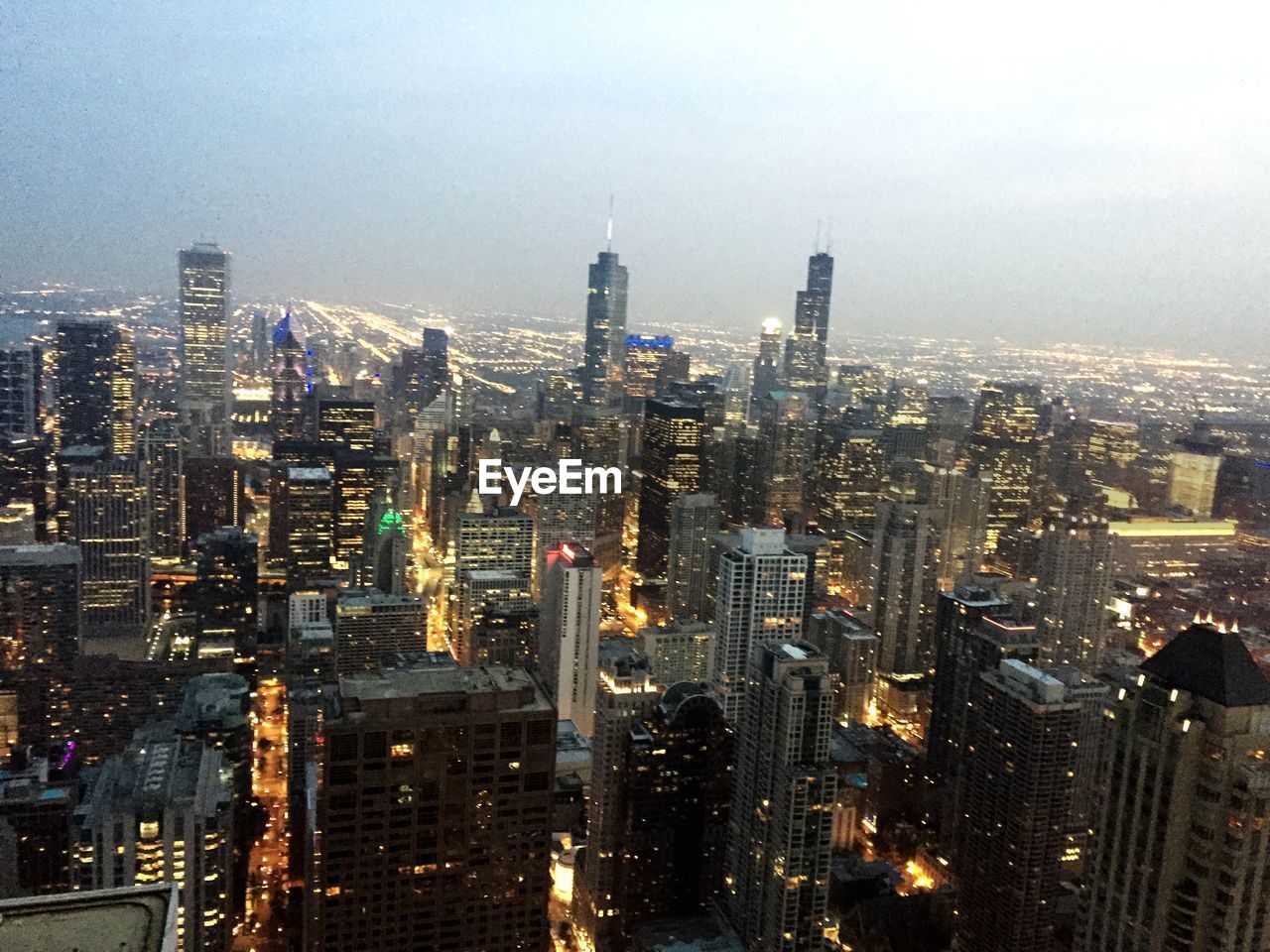 High angle view of illuminated cityscape against clear sky