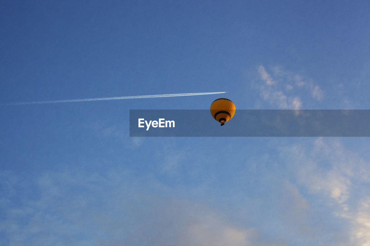 LOW ANGLE VIEW OF HOT AIR BALLOONS IN SKY