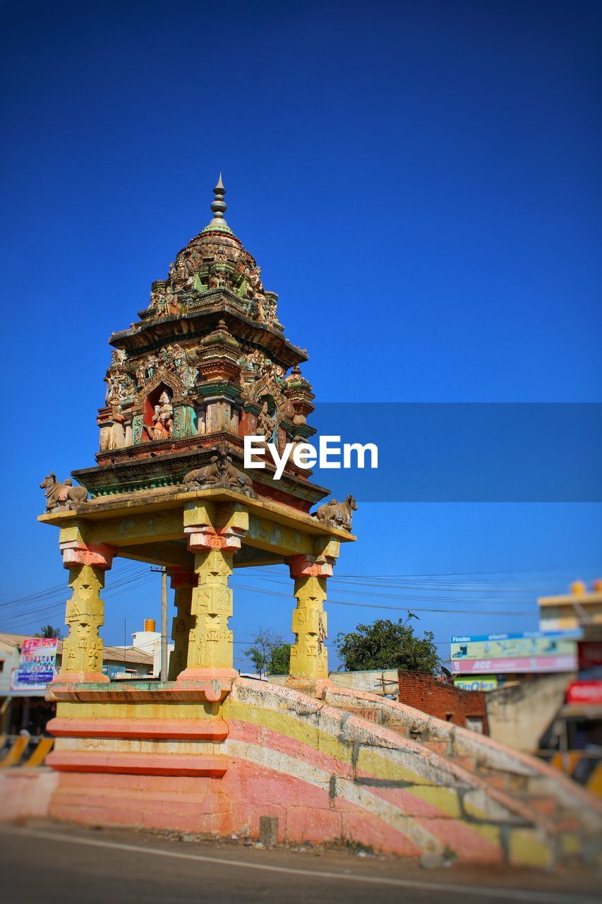 LOW ANGLE VIEW OF TEMPLE AGAINST BUILDING