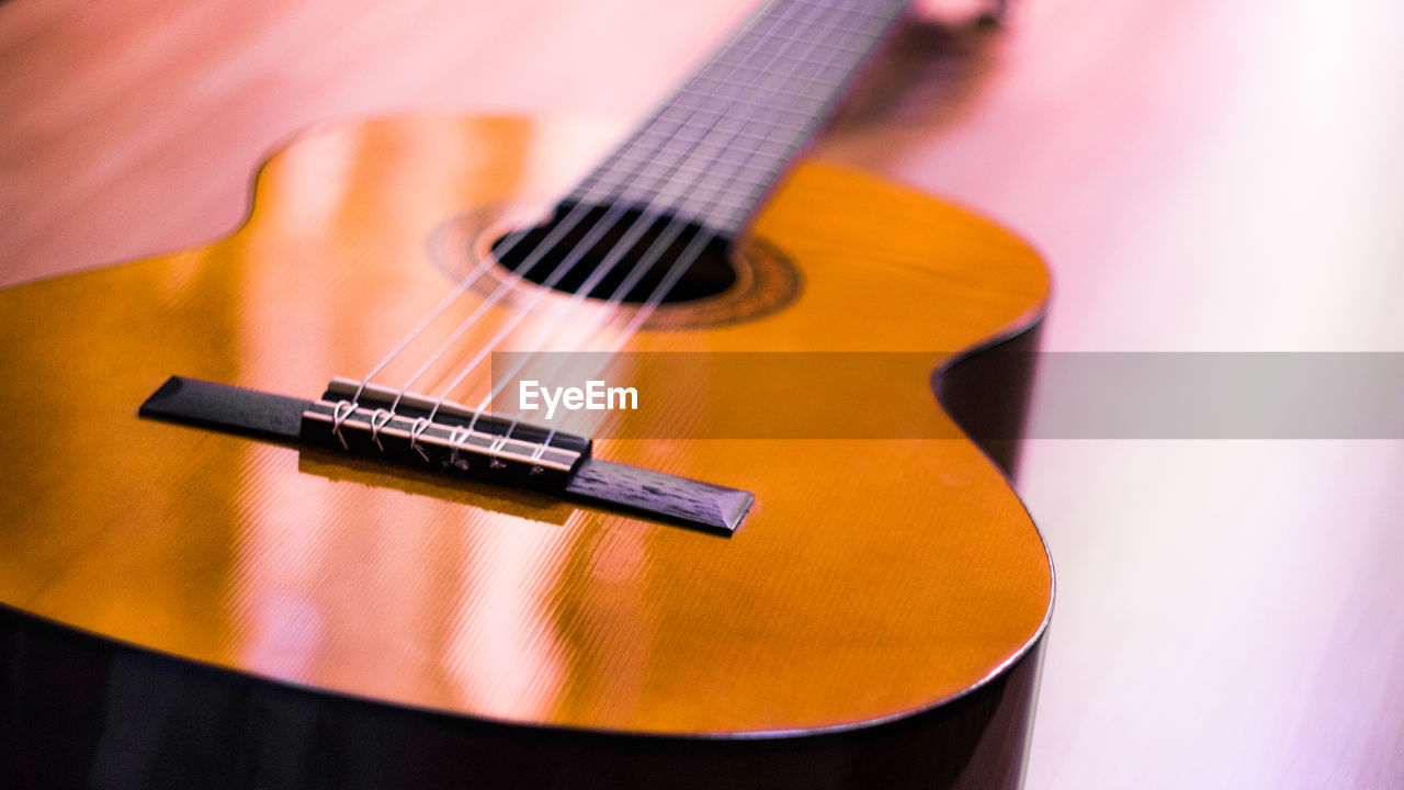 Close-up of guitar on table