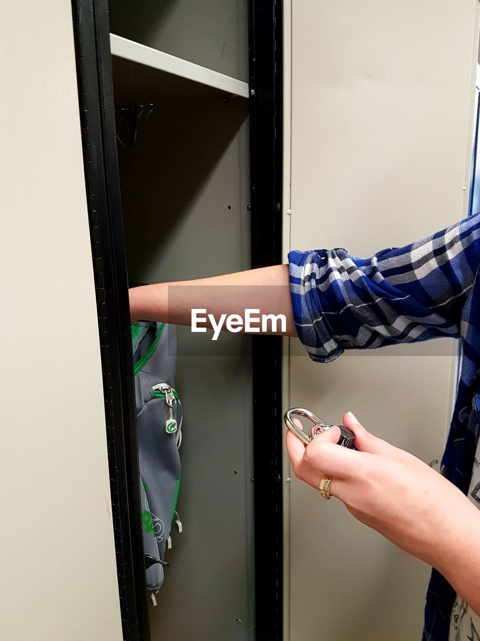 Close-up of hand reaching into locker