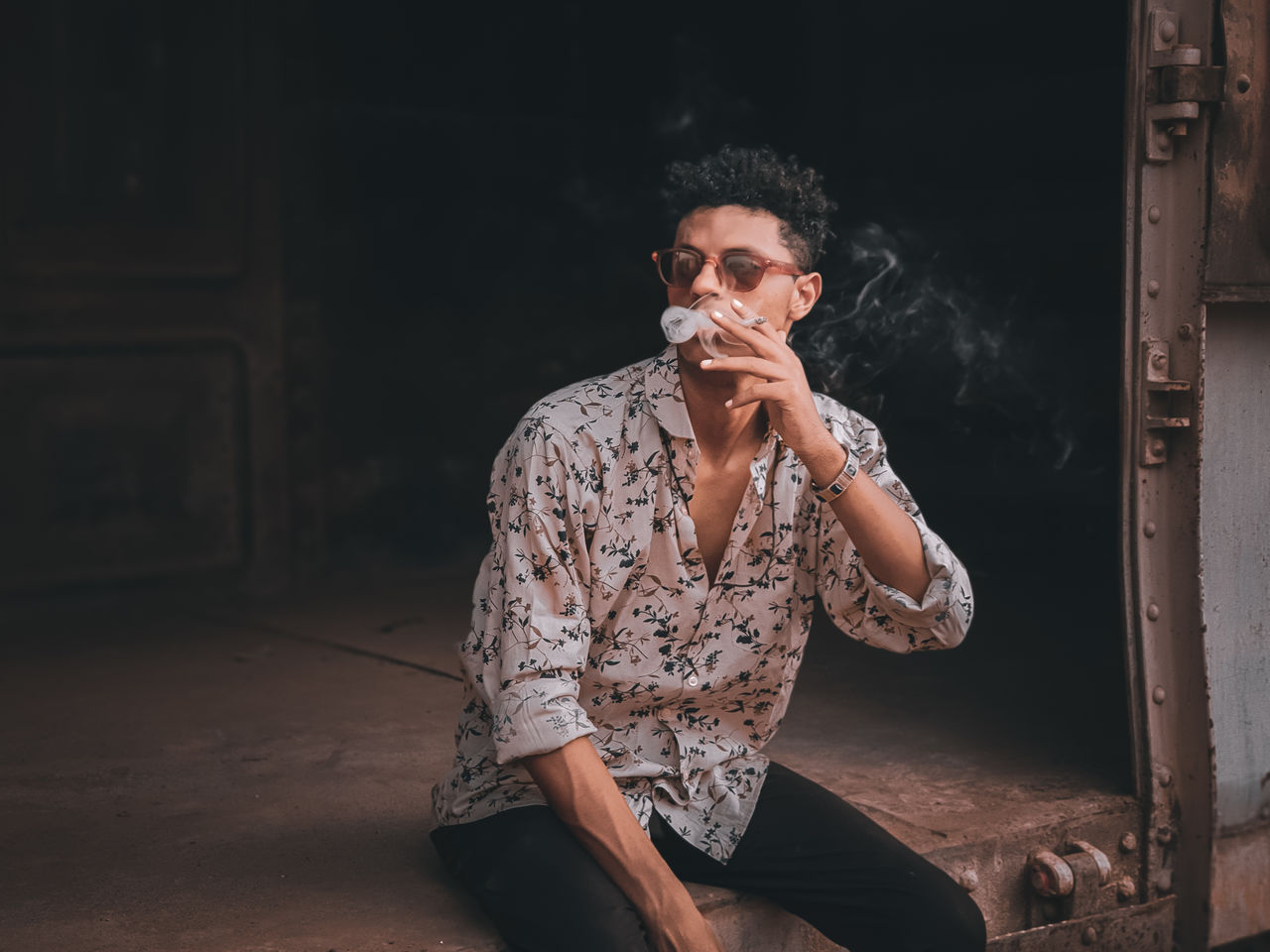 Young man smoking a cigarette in a train 