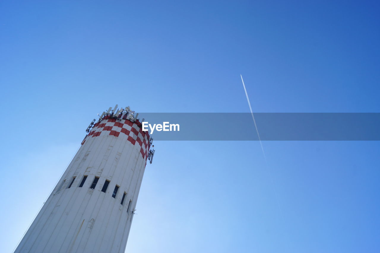 LOW ANGLE VIEW OF VAPOR TRAILS IN SKY