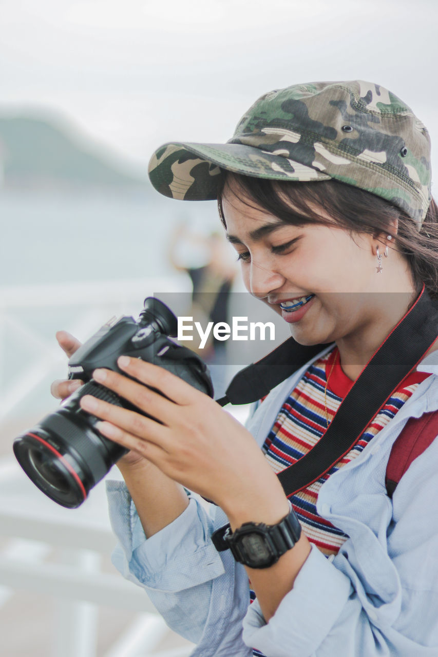 Close-up of woman photographing outdoors