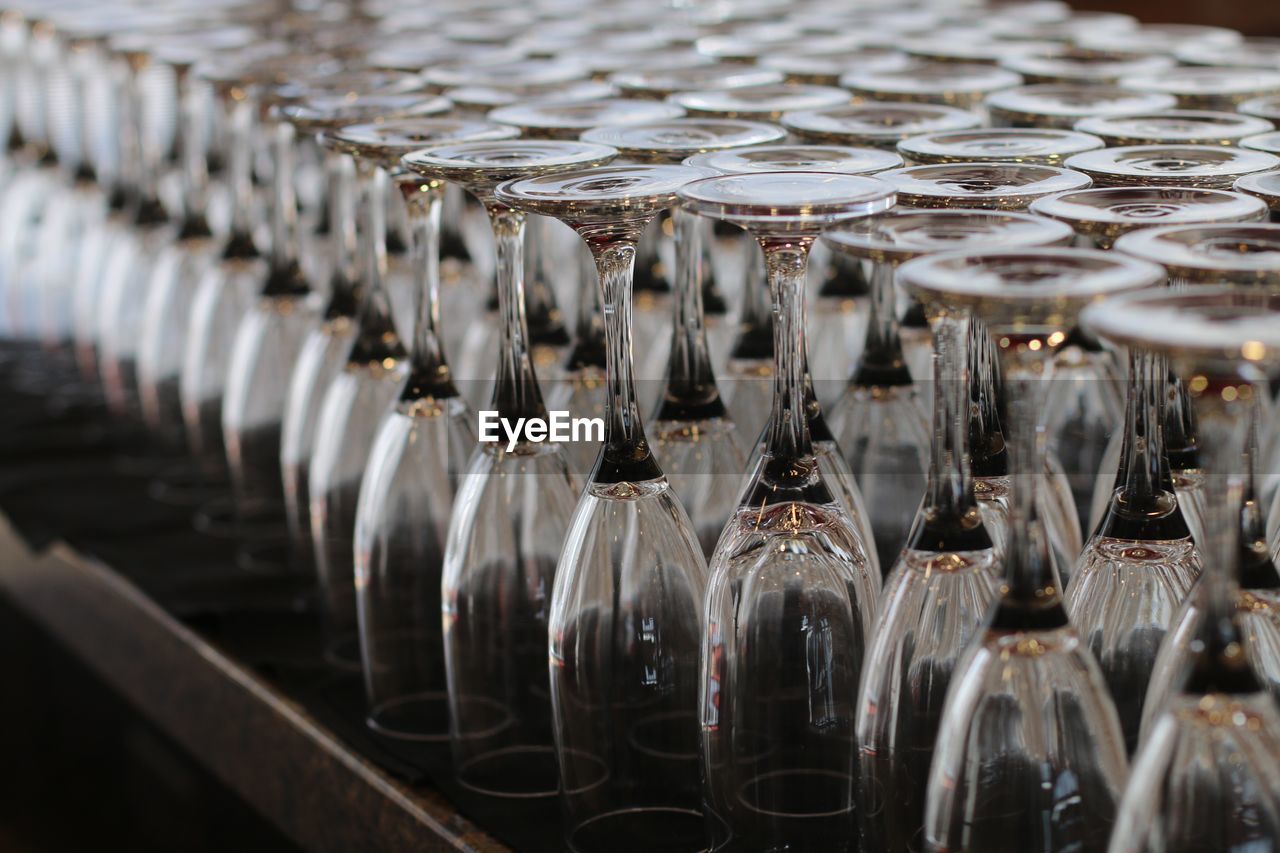 Close-up of upside down champagne flutes arranged on table