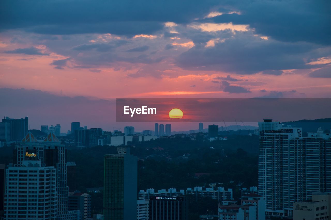 Cityscape against sky during sunset