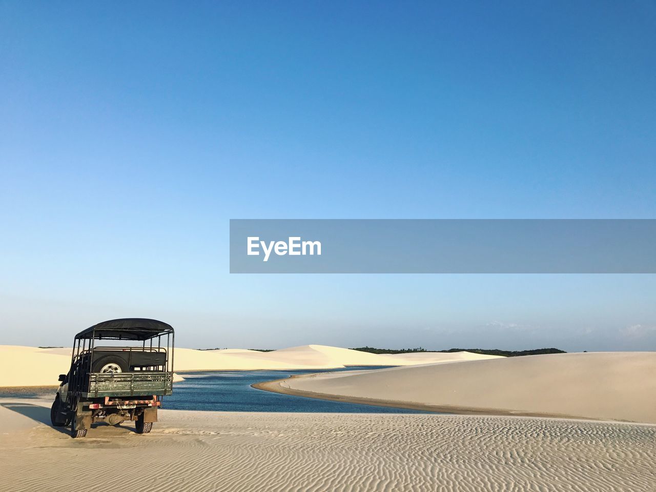 Scenic view of desert against clear blue sky