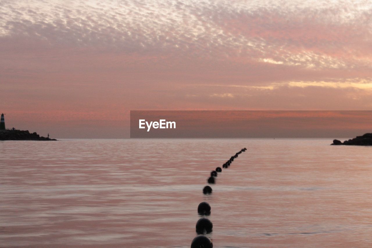 SCENIC VIEW OF SEA AGAINST ORANGE SKY