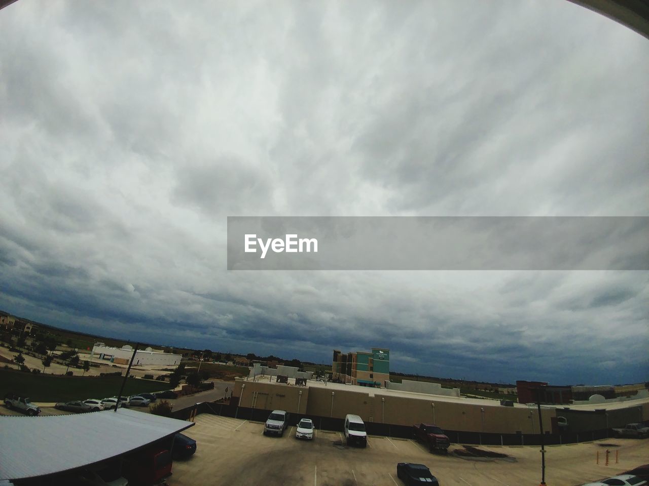 Panoramic view of city against cloudy sky