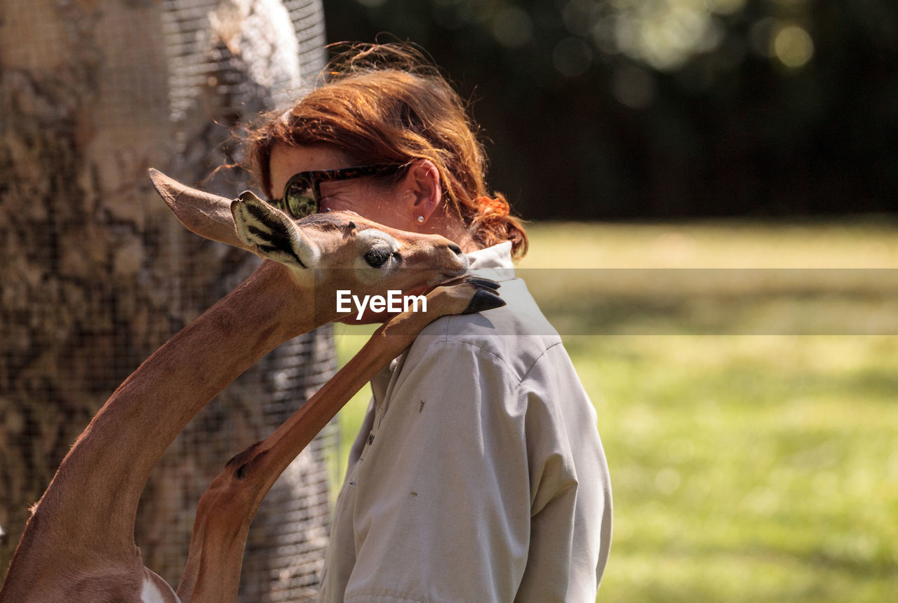 MAN FEEDING BIRD