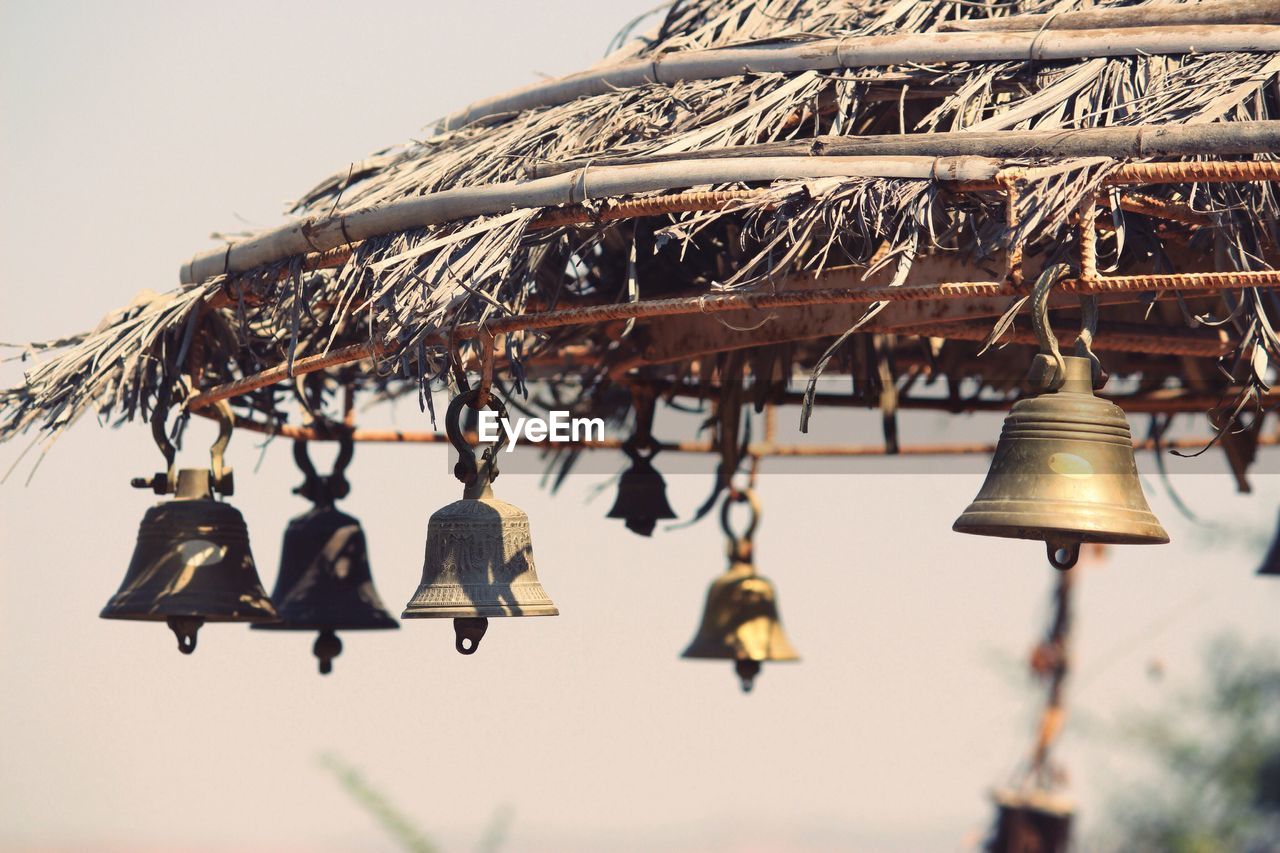 Close-up of bells hanging outdoors