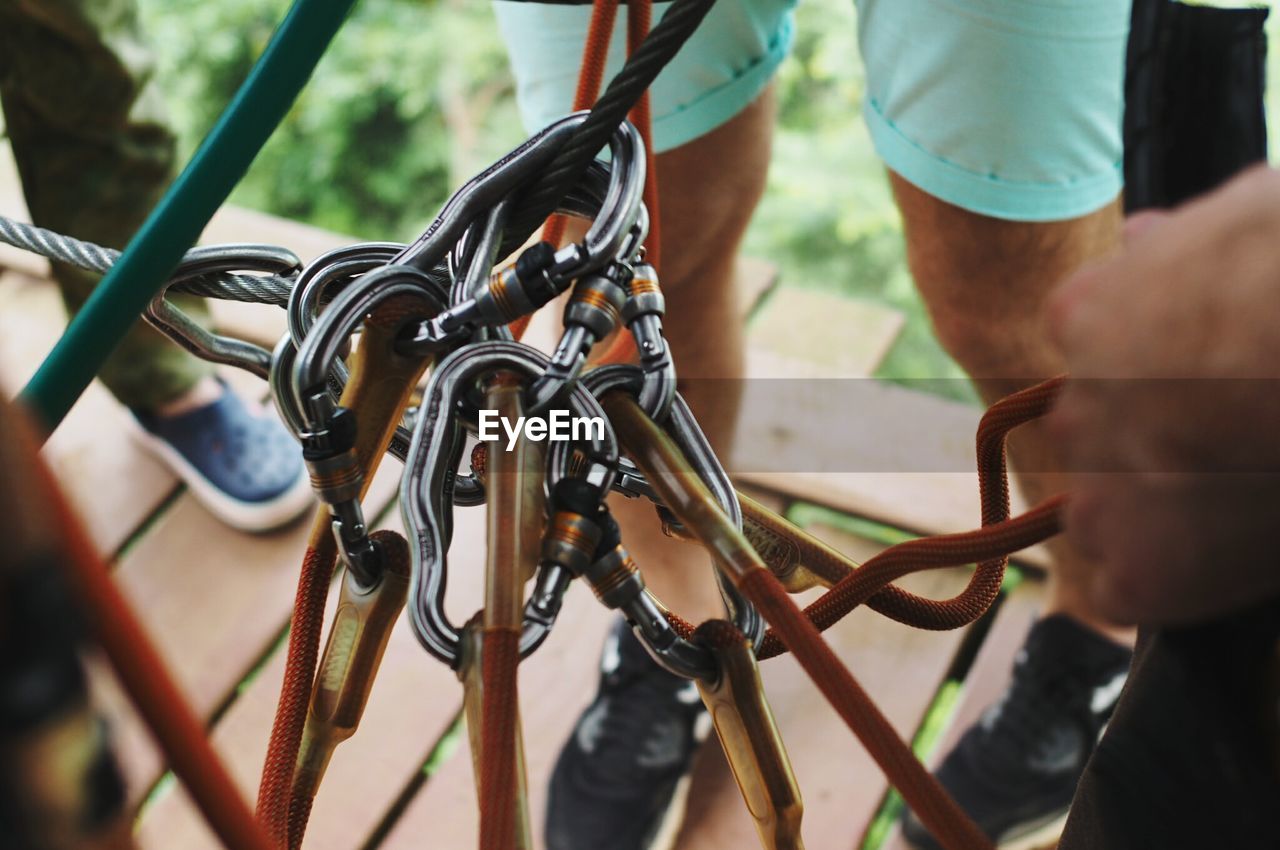 People by safety harnesses on wood