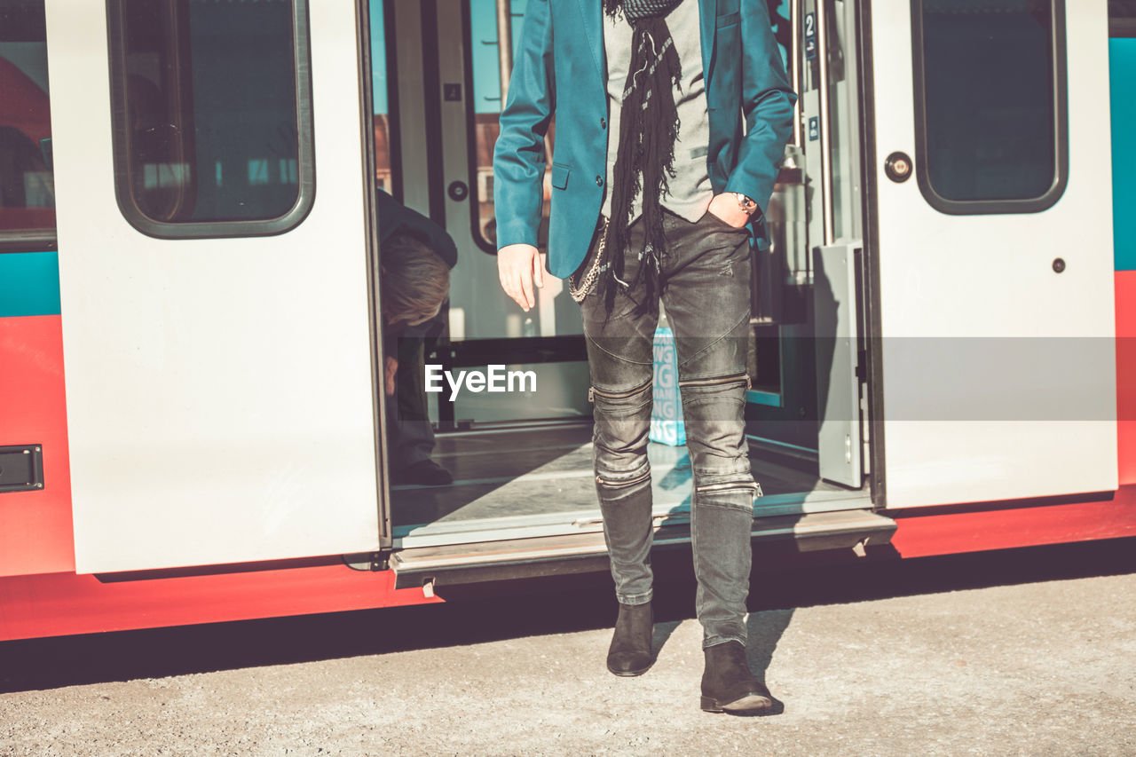 Low section of man walking at railroad station platform