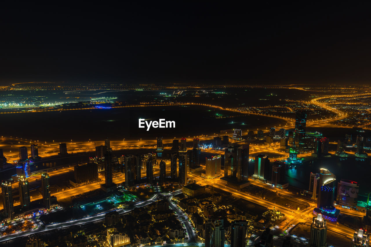 Aerial view of illuminated city buildings at night