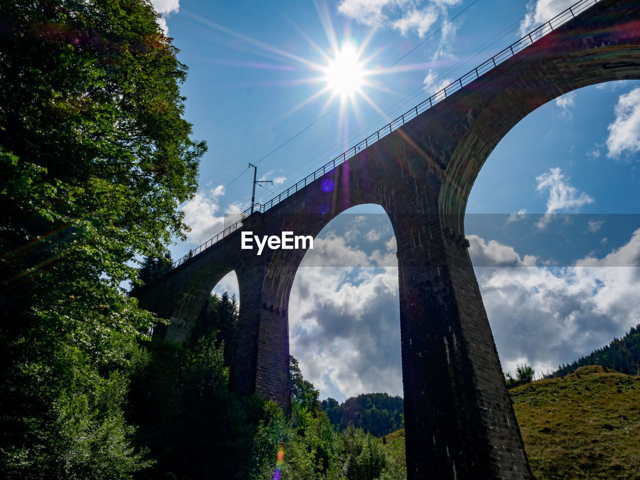 Low angle view of arch bridge against sky