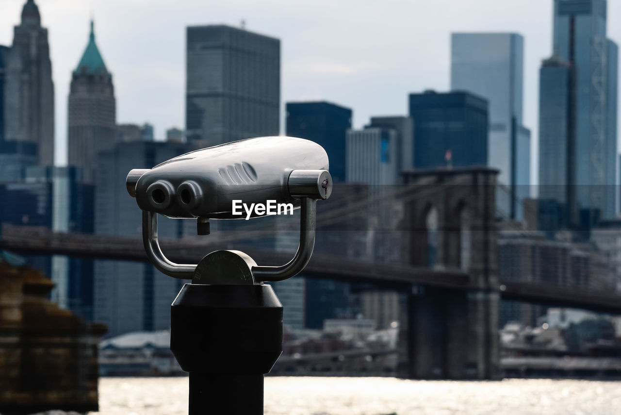 Binoculars against skyline of manhattan