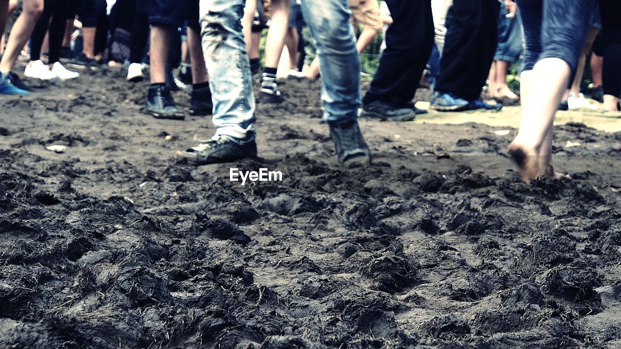 Low section of people on muddy field