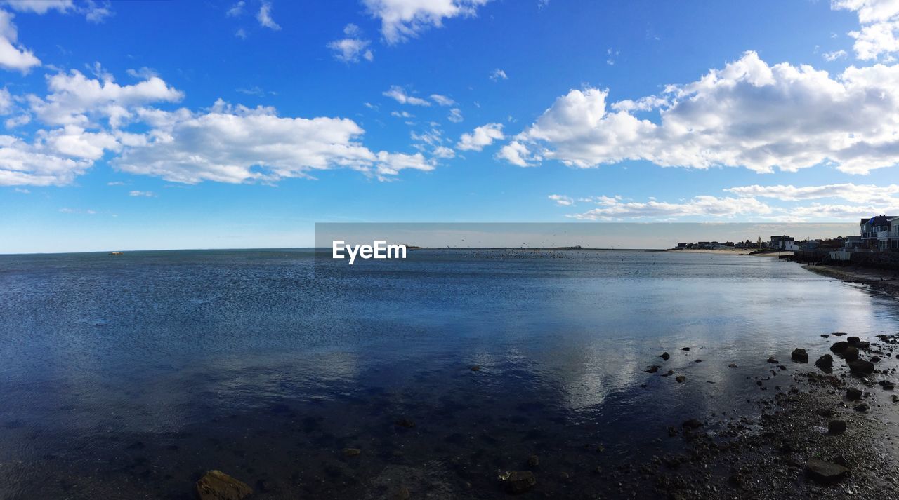 Scenic view of sea against cloudy sky