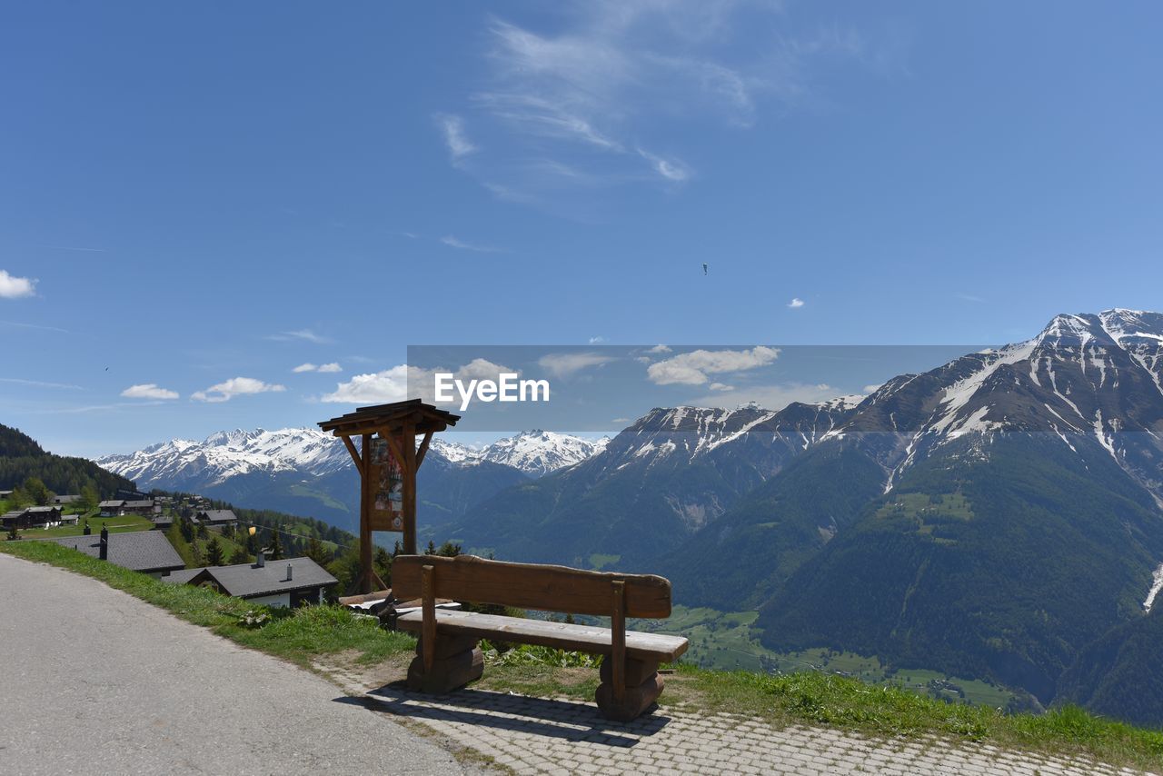 Bench against scenic view of mountains against sky