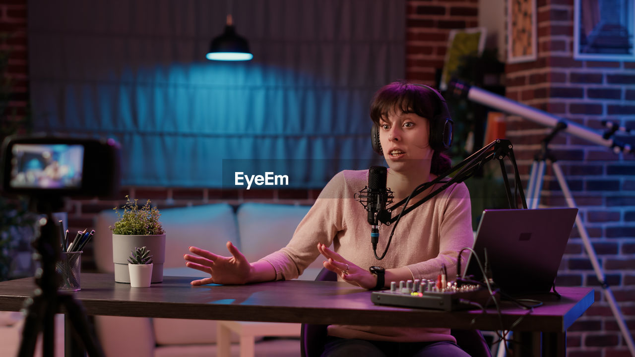 portrait of young woman using laptop at table