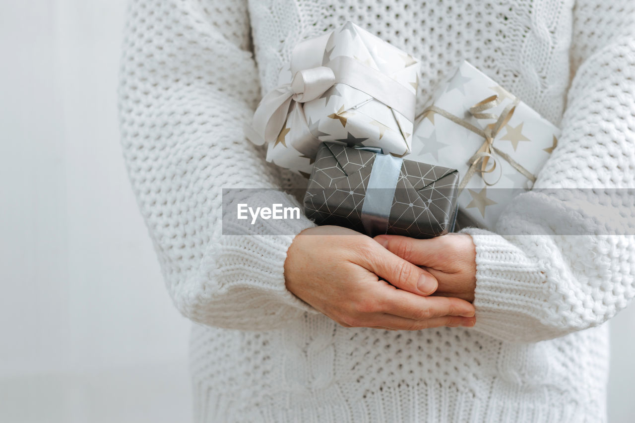 Midsection of woman holding gift boxes