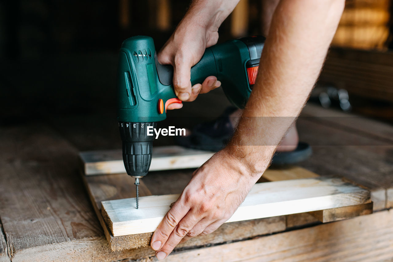 Midsection of man working in workshop