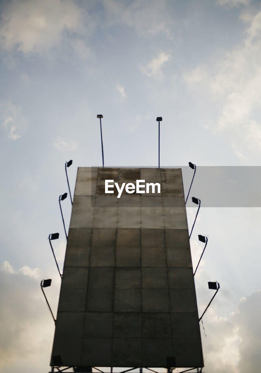 Low angle view of billboard against sky