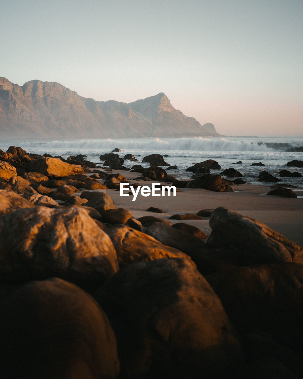 ROCKS ON BEACH AGAINST SKY