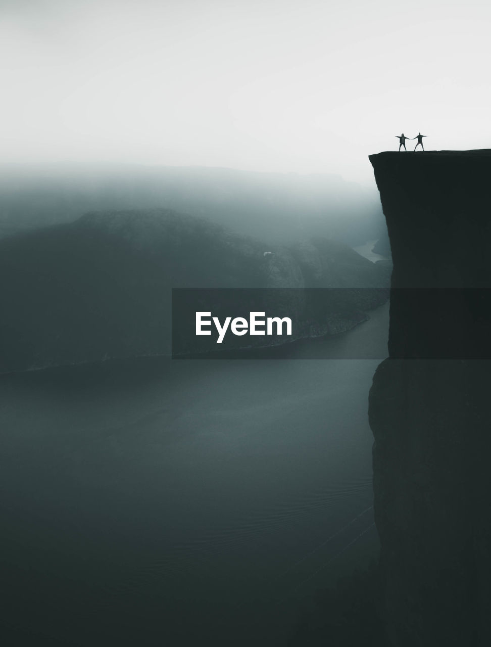 Scenic view of sea and mountains against sky