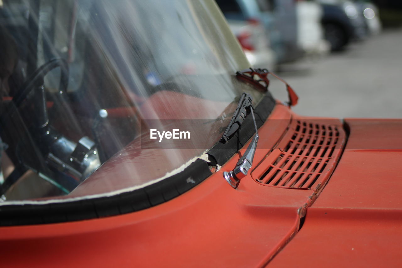 Close up of red car in parking lot