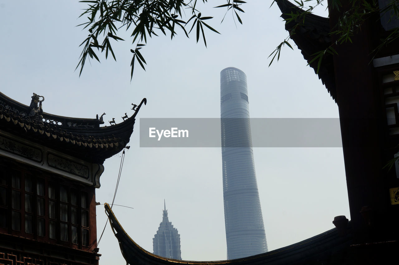 Low angle view of jin mao tower and shanghai tower against clear sky