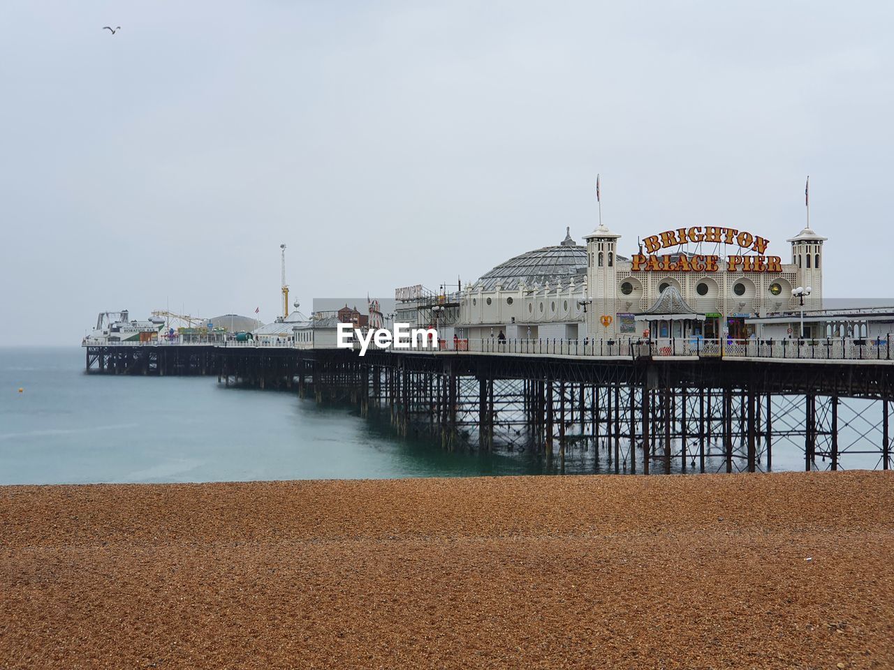 PIER ON BEACH AGAINST SKY